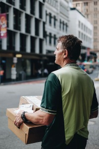 Delivery person holding parcels