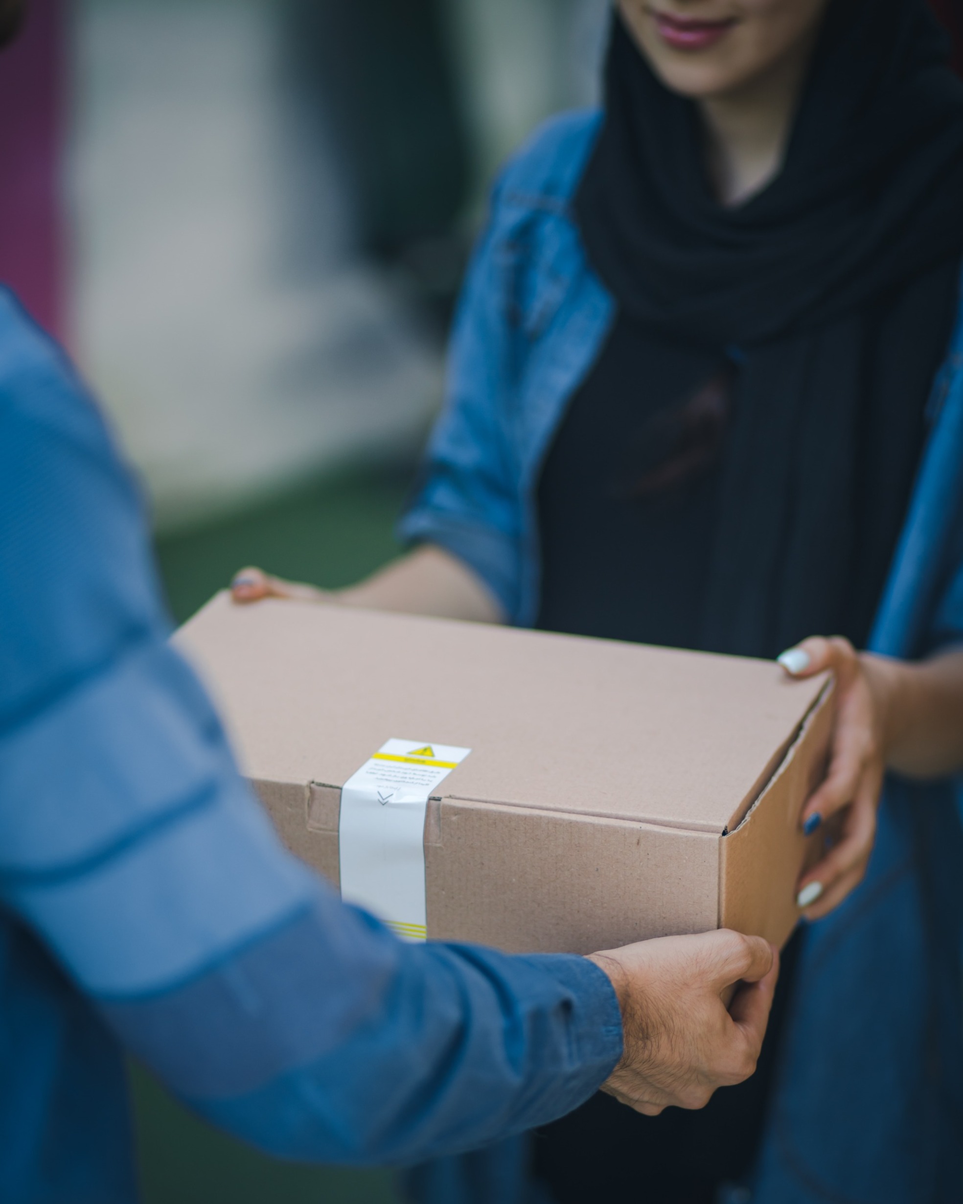 rosebox-BFdSCxmqvYc-unsplash (2) person giving another person a parcel